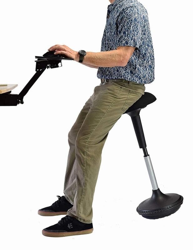 A man sitting on a black sitting stand